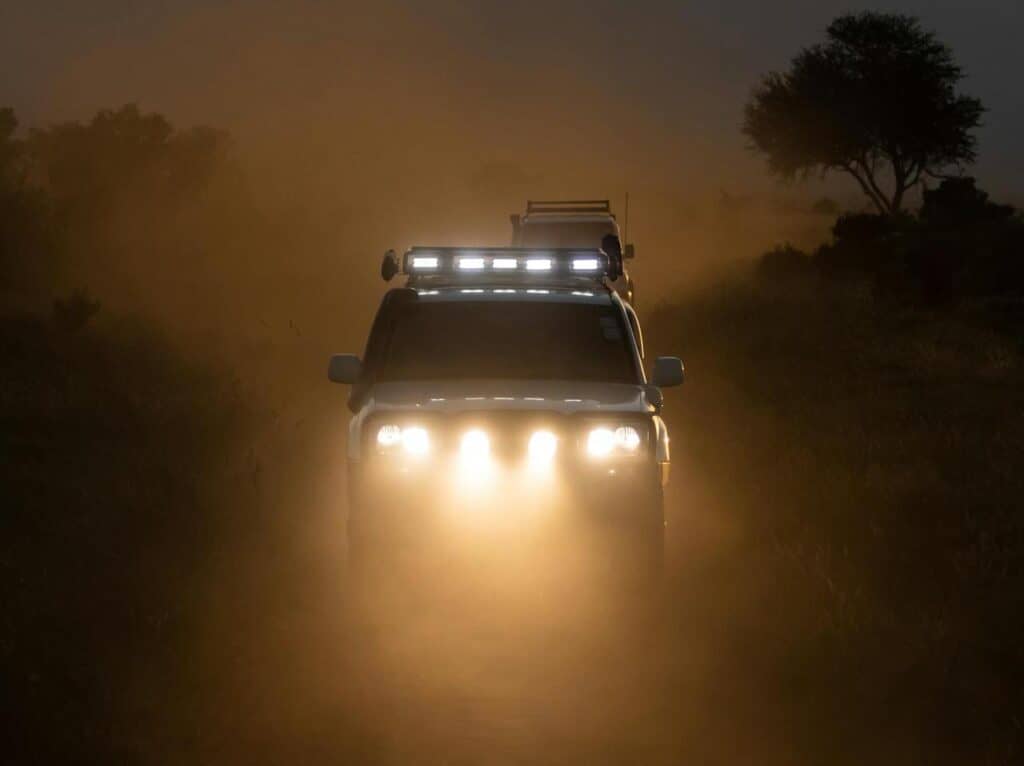 Car headlights flashing at dusk