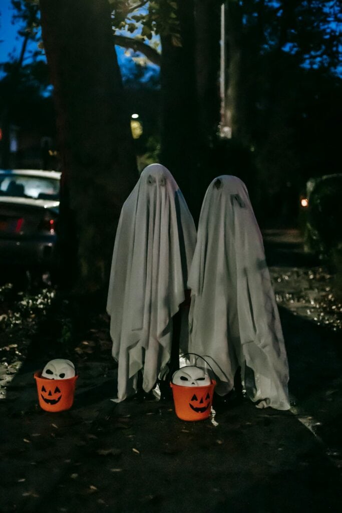 Children walking in a small-town Halloween parade,