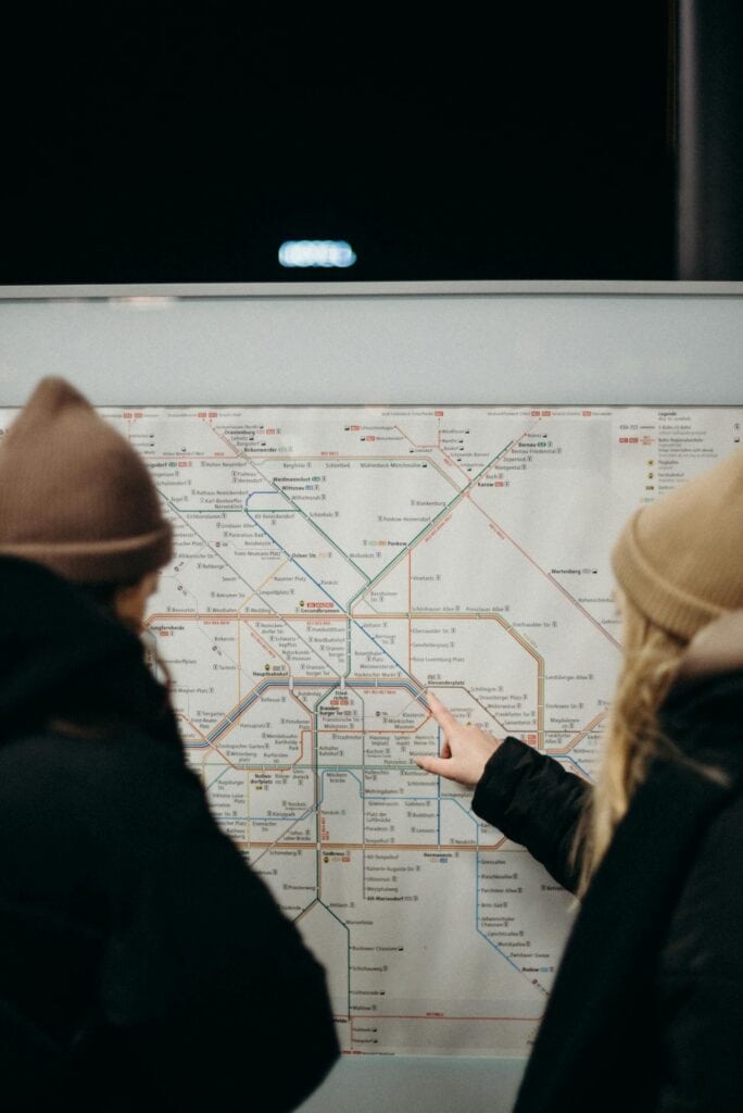 Couple Navigating Subway Map at Night Station