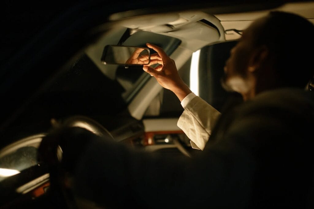 Driver adjusting a mirror before towing.
