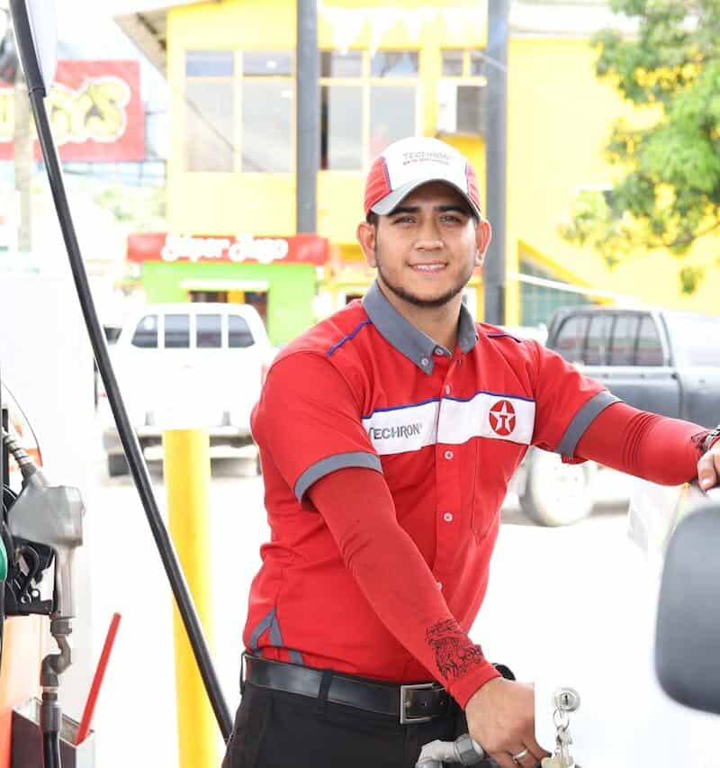 Gas station attendant refueling a car