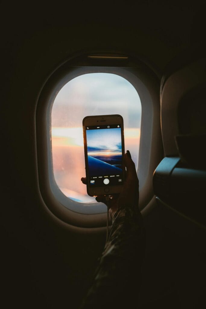 Window seat view with a person resting against the side.