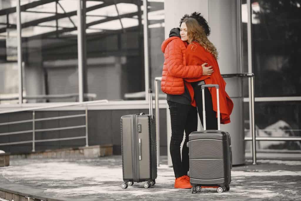 airport goodbye hug in silhouette,