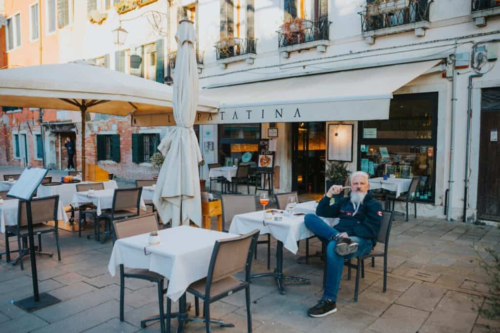A traveler journaling at a quiet café overlooking