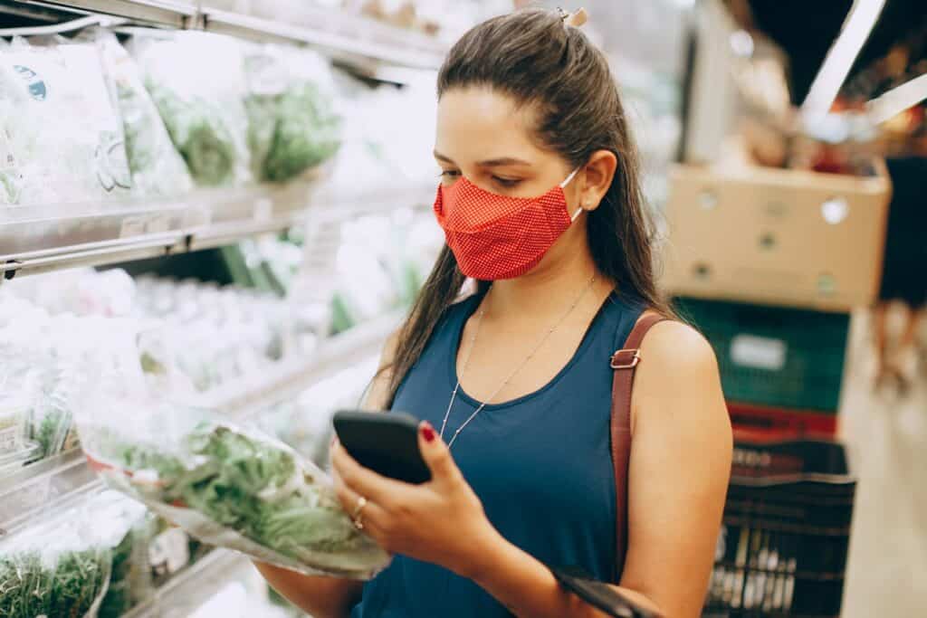A shopper scanning a grocery list on their phone