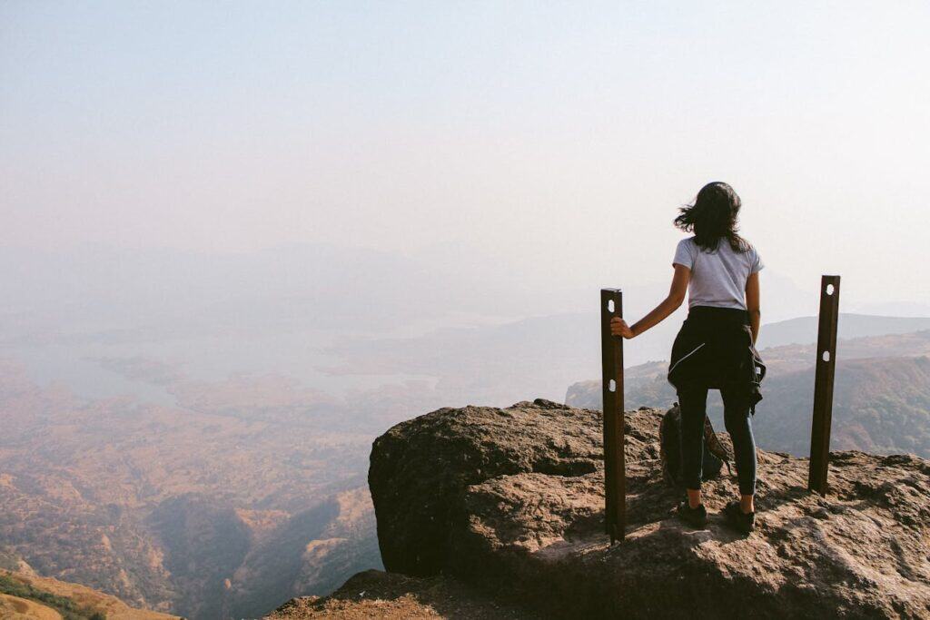 hiker standing near roped-off area.