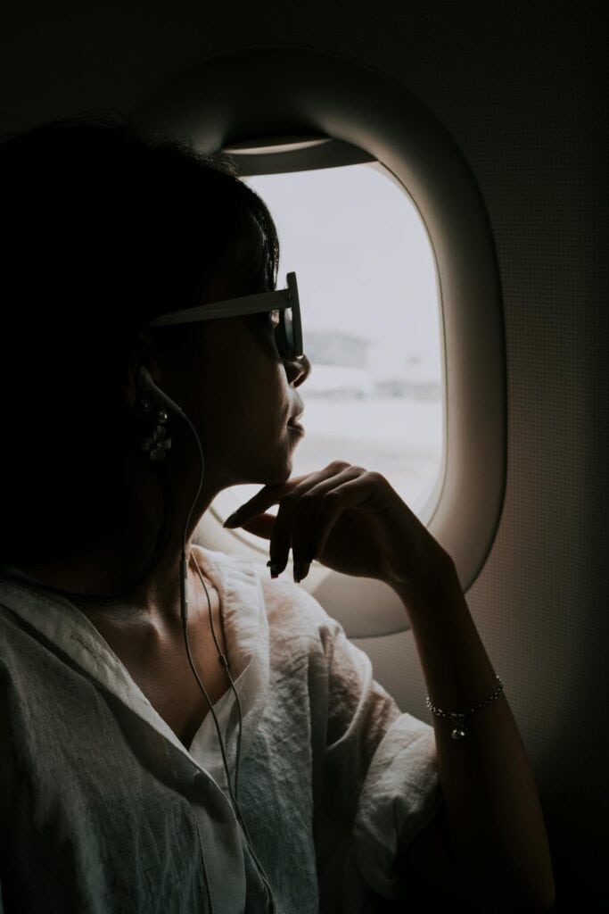 Traveler in a relaxed position with headphones on.