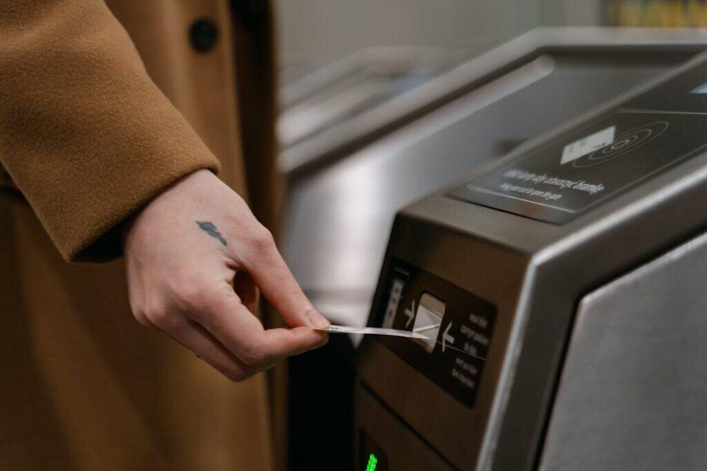 traveler tapping a credit card on a contactless metro gate in Singapore
