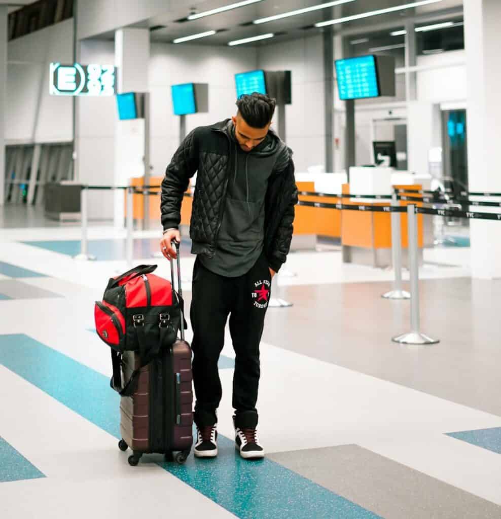 A traveler walking through an airport with just a carry-on