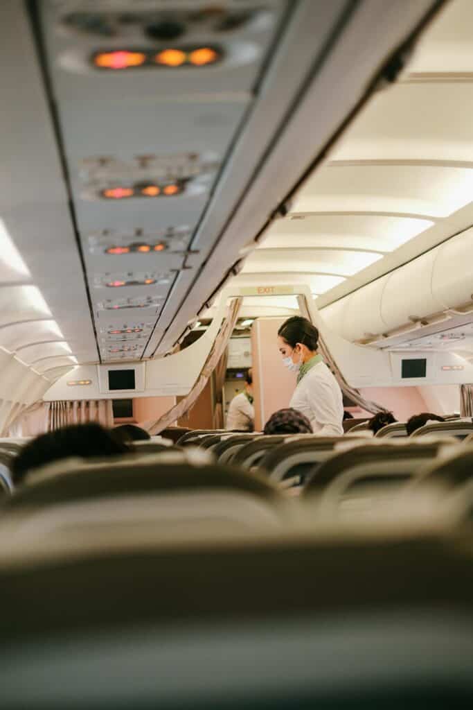 Flight attendant passing by in the aisle.