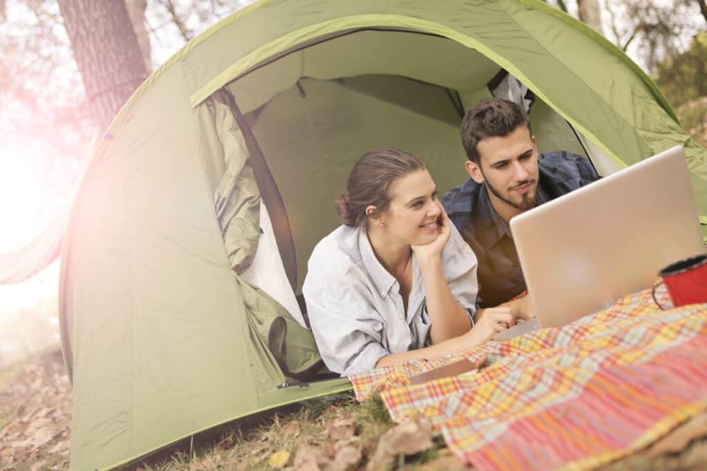 A traveler at a laptop surrounded by fall colors,