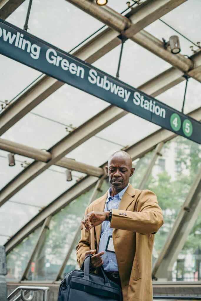 Traveler checking their watch or waiting at a train station.