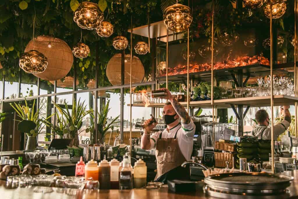 Sustainable bar setup with glass straws, local ingredients, and recycled décor.