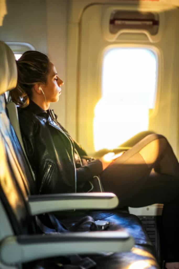 Peaceful woman gazing out airplane window