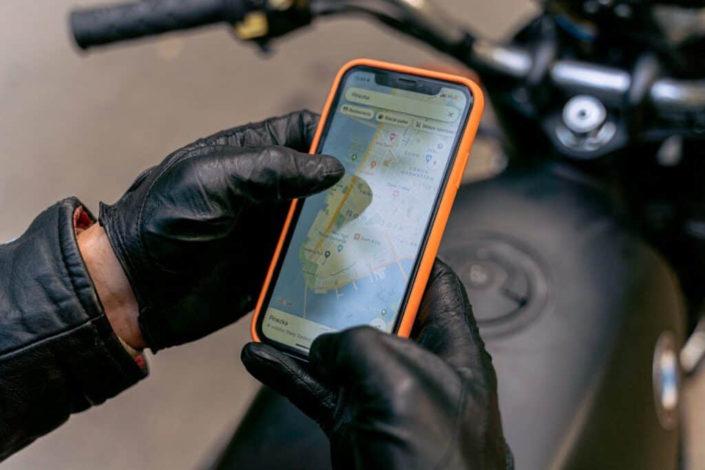 Motorcycle rider looking at map outdoors