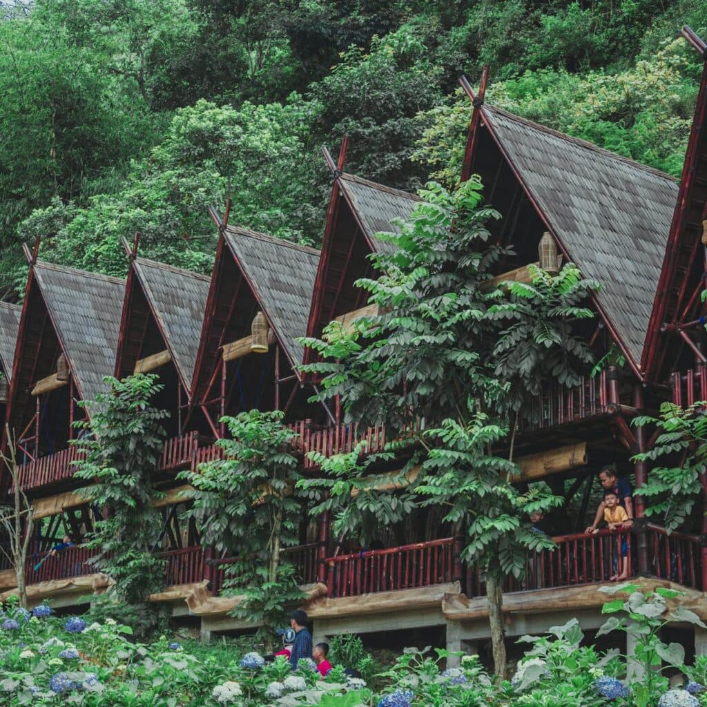A small eco-lodge surrounded by greenery, symbolizing sustainable travel.