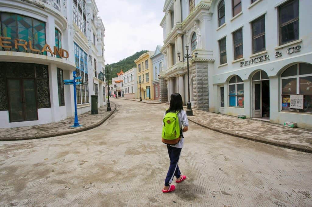 Traveler with a compact backpack on a quiet street.