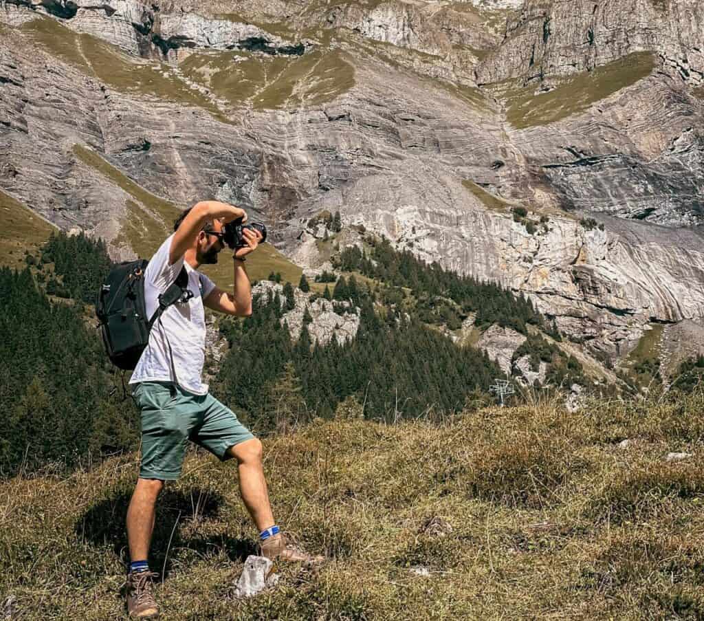 close-up of a hiker photographing rocks