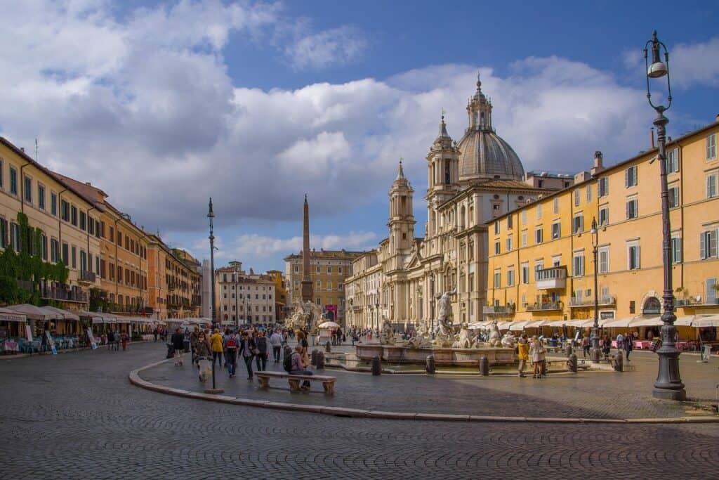 Ancient Spanish Steps in Rome, Italy, with visitors and Twin Churches in the background.