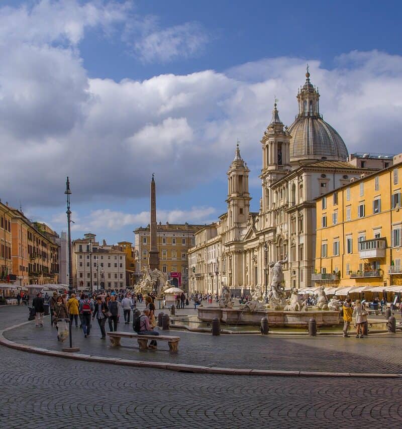 Ancient Spanish Steps in Rome, Italy, with visitors and Twin Churches in the background.