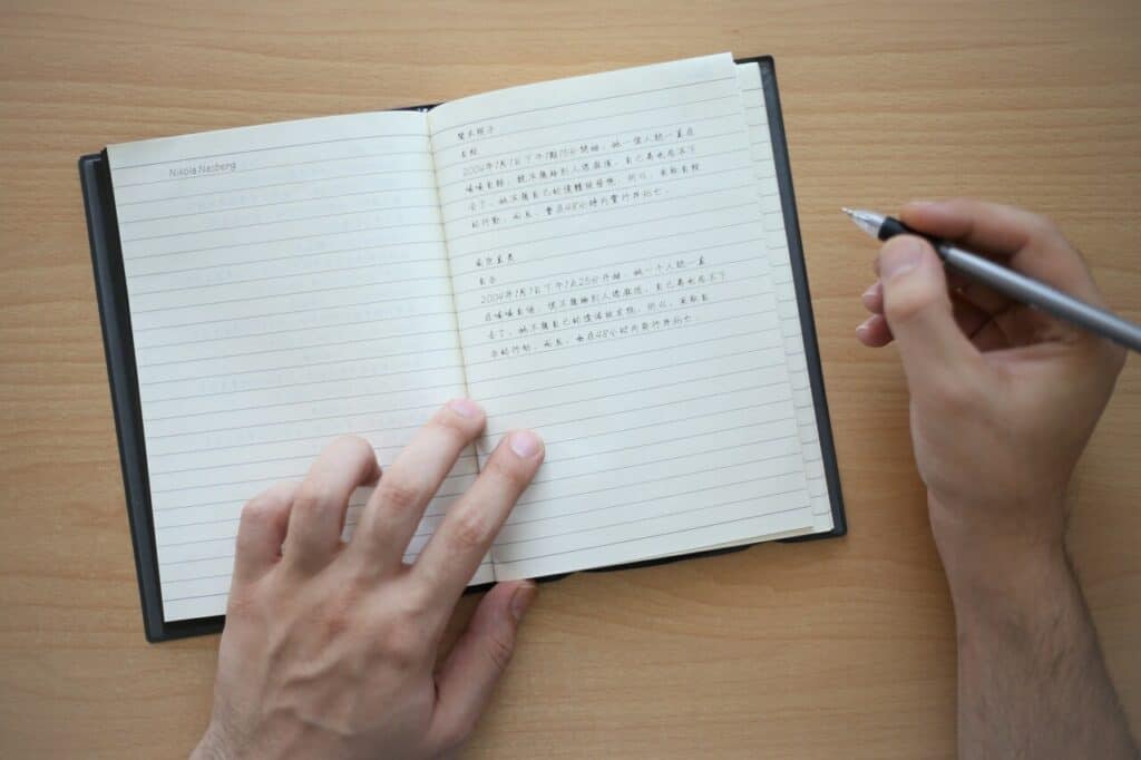 a notebook written emergency contact info