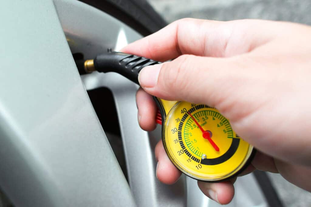 Close-up of a tire gauge checking RV tire pressure.