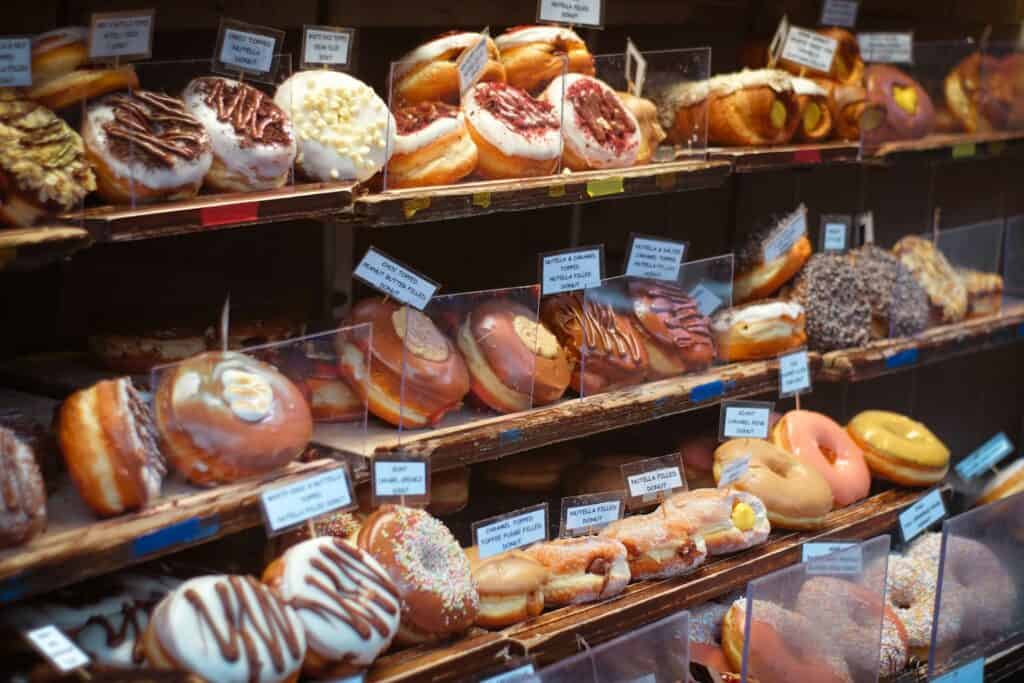 A colorful display of artisan donuts in a local shop