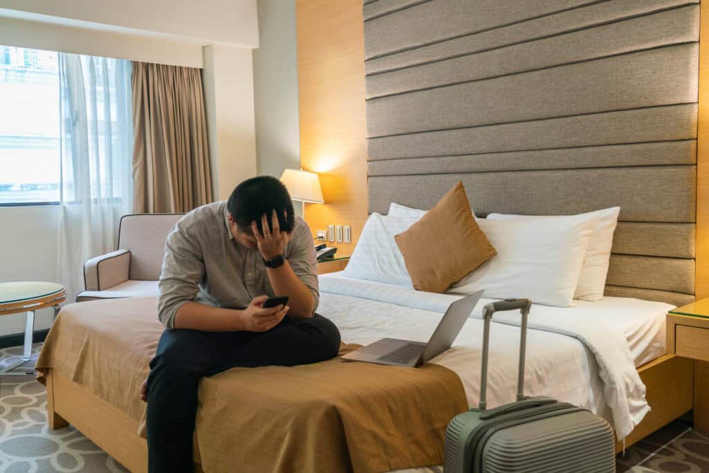 frustrated guest in hotel room with suitcase open
