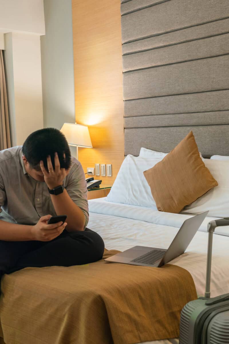 frustrated guest in hotel room with suitcase open