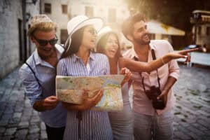 Happy group of friends enjoying sightseeing tour in the city.
