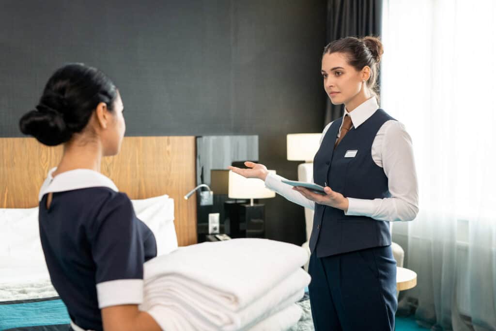 hotel staff checking room inventory tablet housekeeping audit