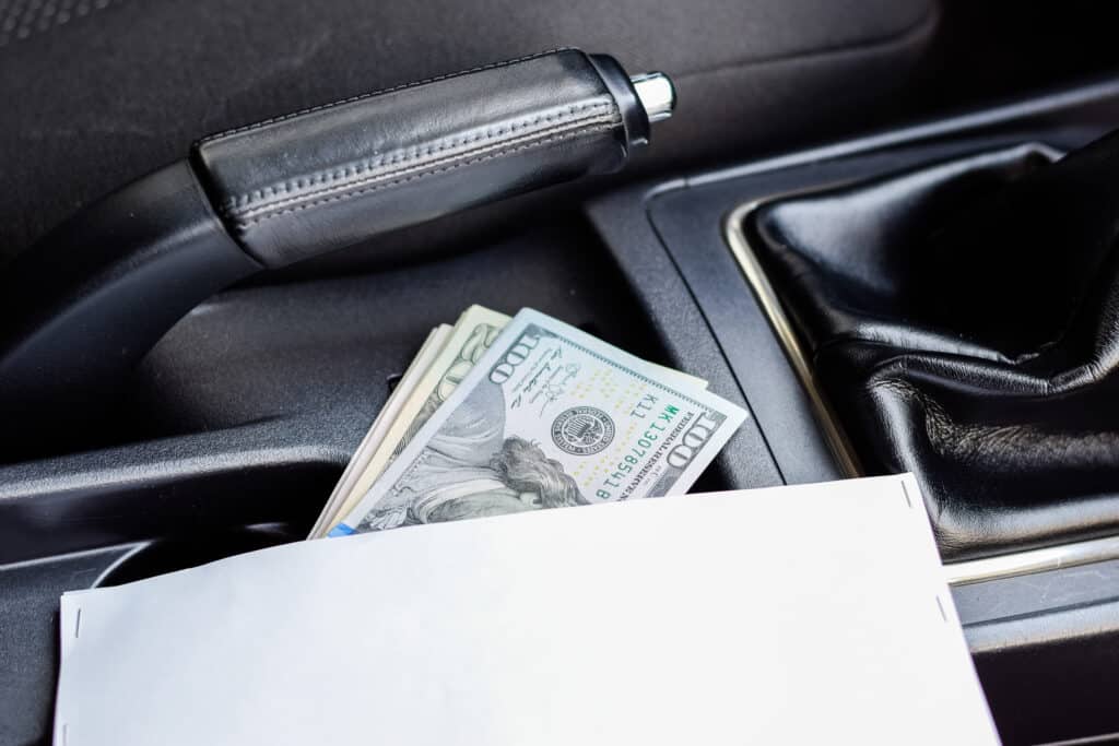 cash inside car console, coins in car tray, wallet visible in car