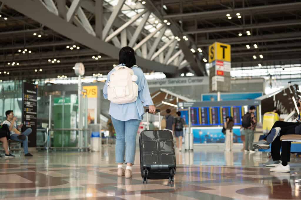 traveler walking through airport calm mood