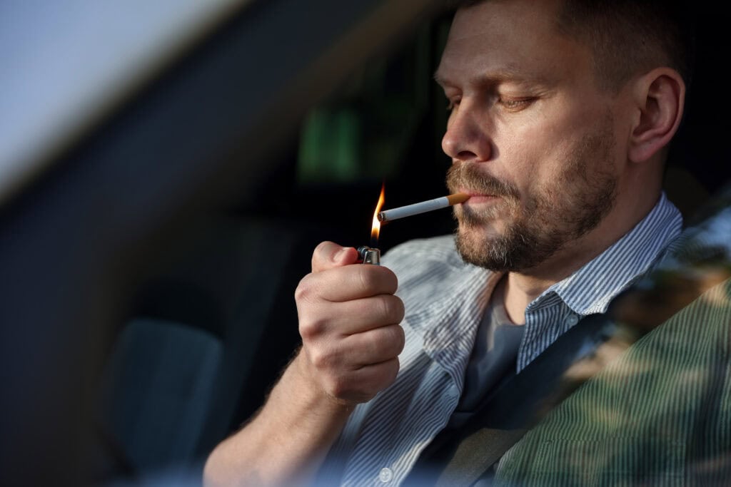 Men smoking in car