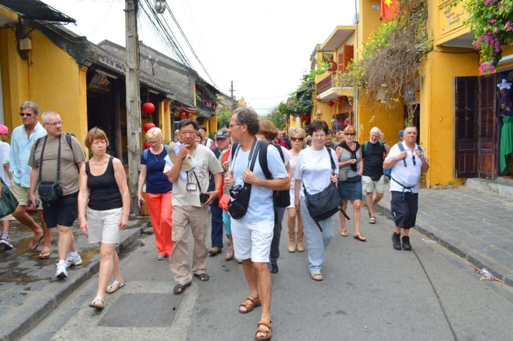 local guide leading tourists small group village