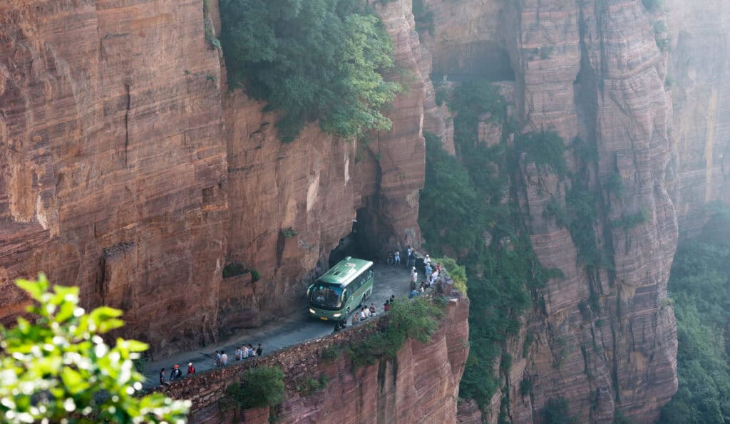 tourist car narrow cliffside road hazard