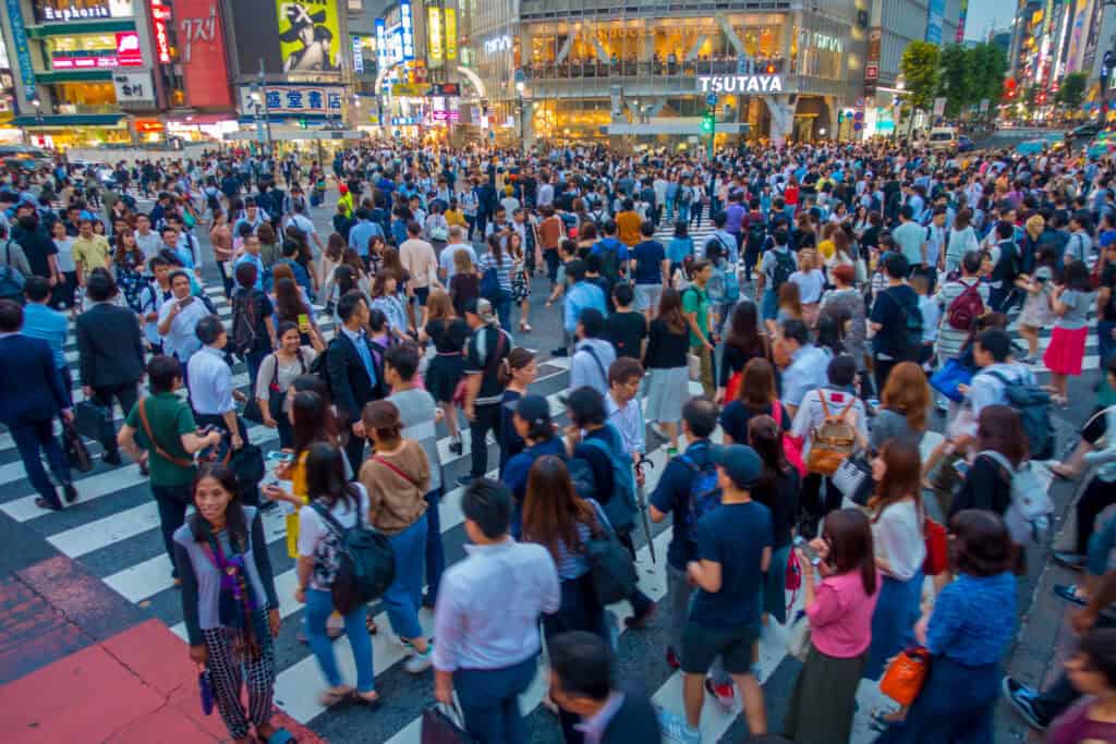 Walking And Eating Through Crowded Streets