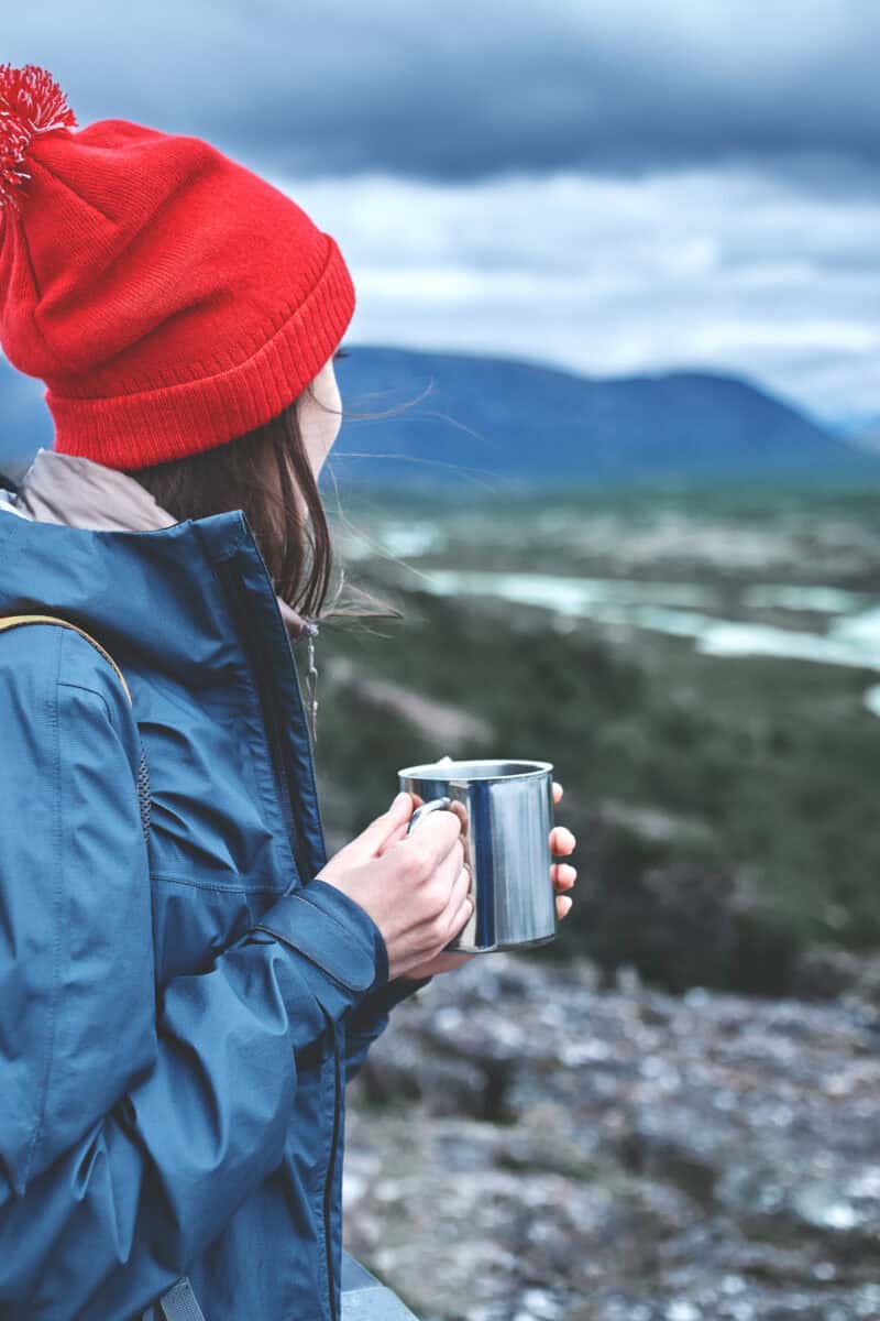 Cheerful woman drink tea on nature