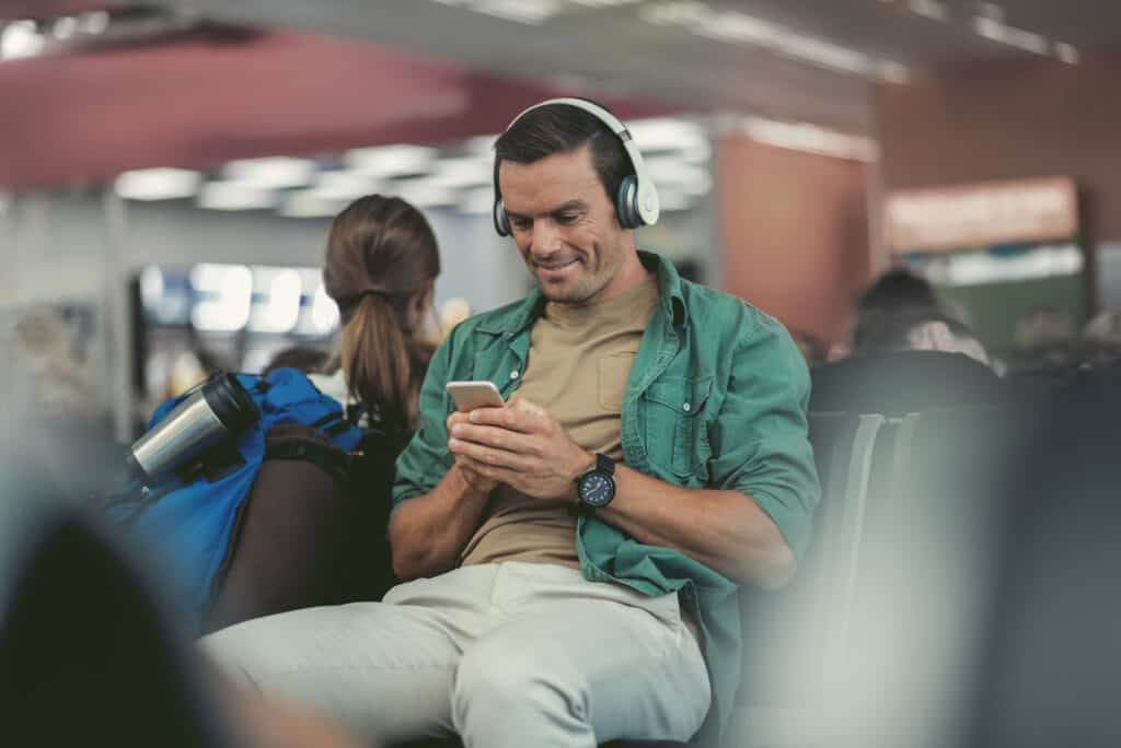 “tourist wearing headphones airport