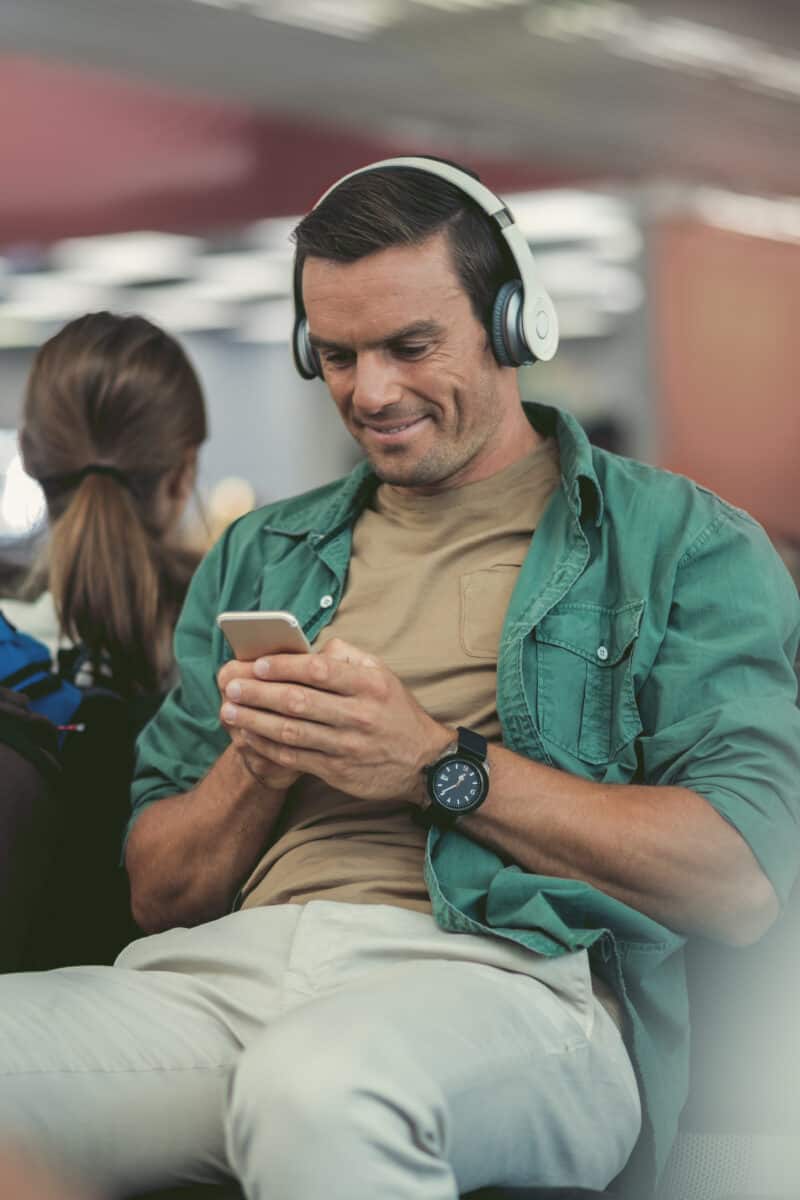 “tourist wearing headphones airport