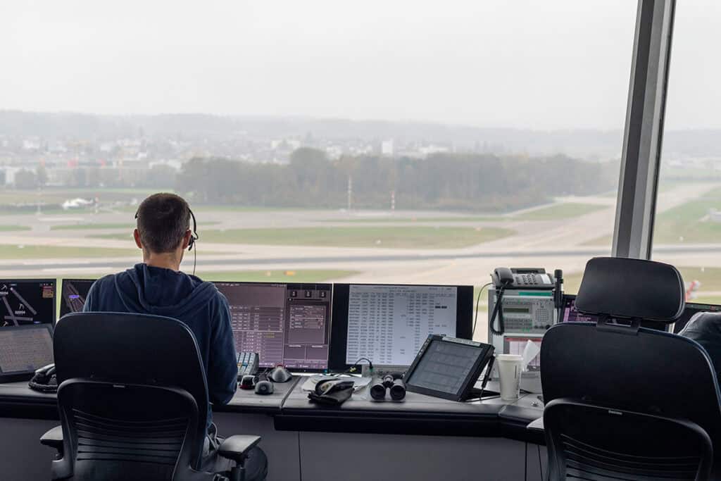 airline control center staff flight schedule screens