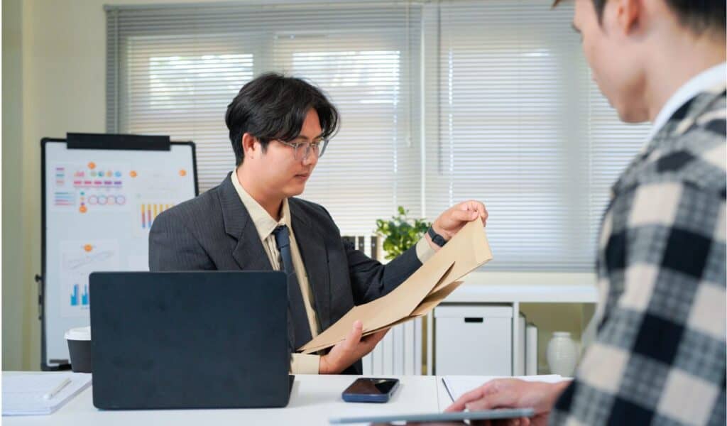 Application, hands and interview with business people in human resources office for hiring or recruitment. CV, documents or resume with manager and candidate talking in office for job opportunity.