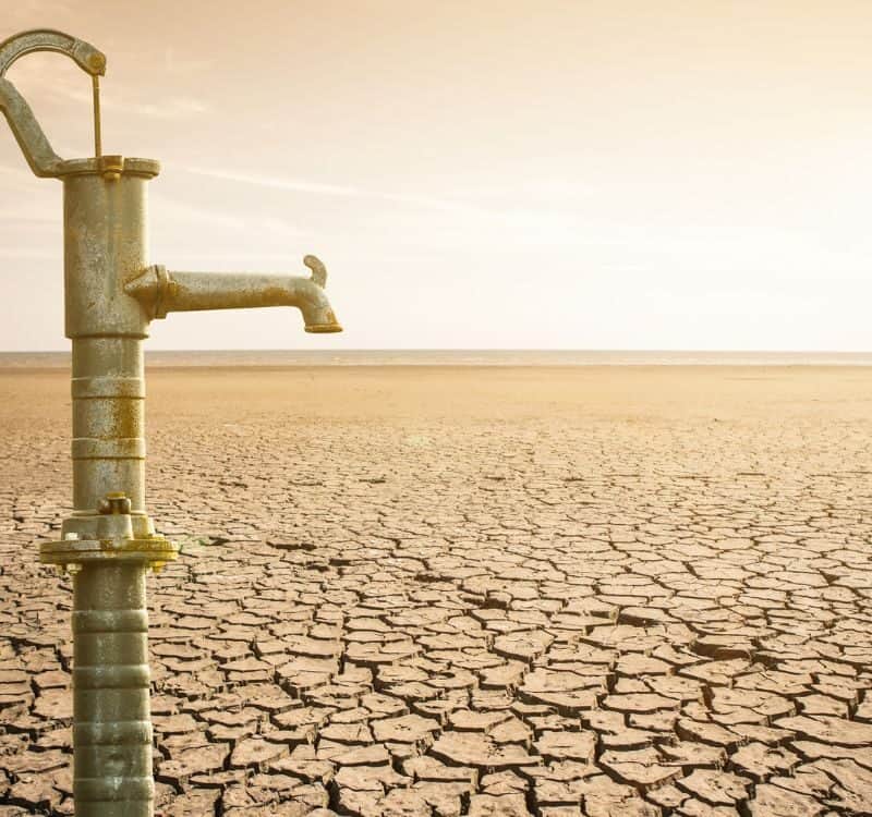 Dry cracked desert with old water pipe