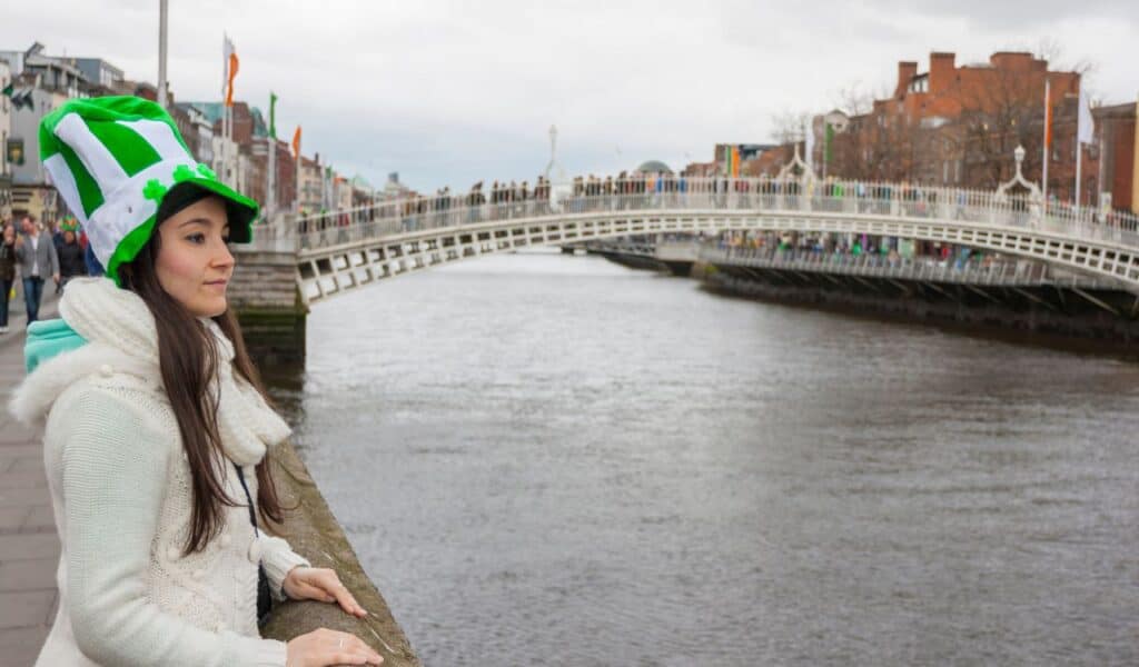 Girl at River liffey close to Hapenny bridge in Dublin