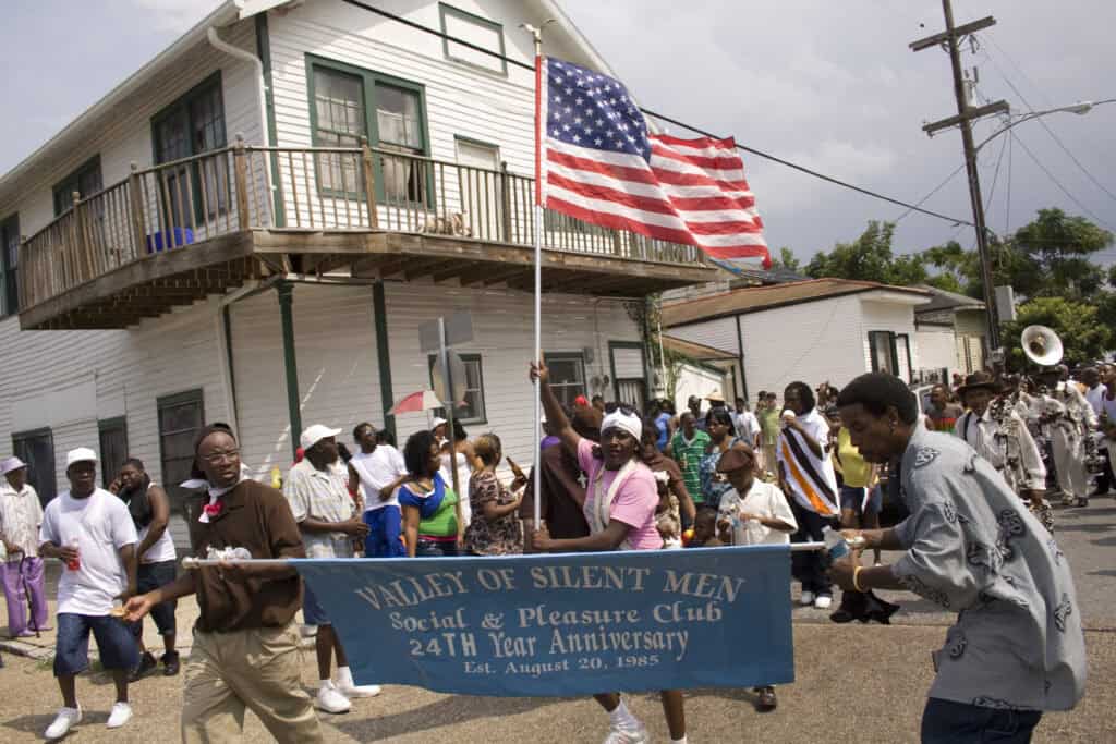 American flag flying at a parade celebrating community and cultural heritage.