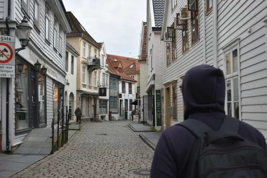 traveler exploring cobblestone street small European town