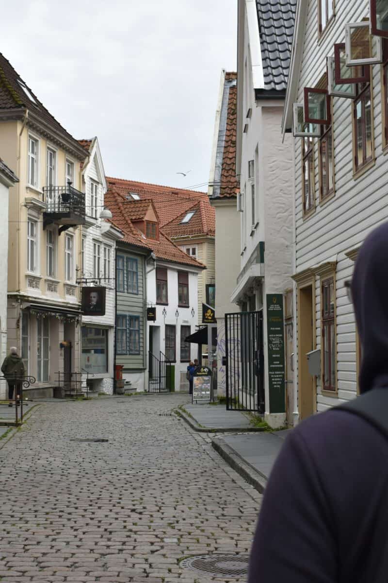 traveler exploring cobblestone street small European town