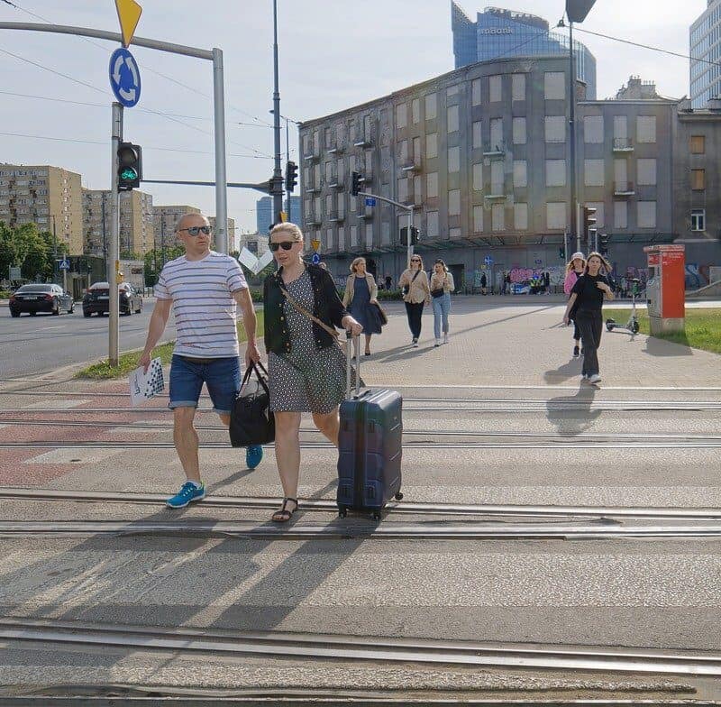 city walking tour group streets tourists guide leading crowd”