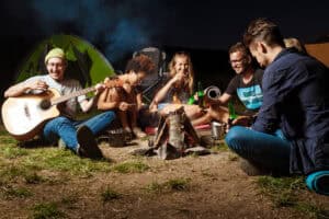 : large group campsite party night, crowded campsite loud group, campground group gathering music