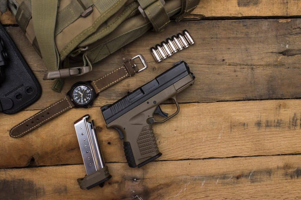 High-quality semi-automatic handgun with magazine, watch, and ammunition.